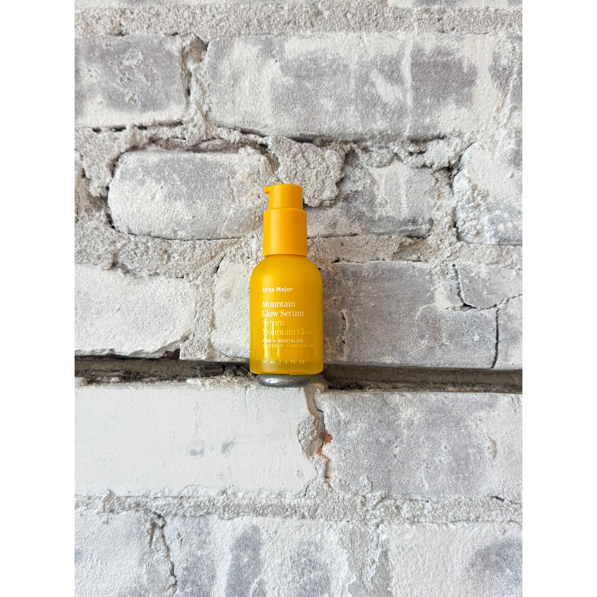 Ursa Major Mountain Glow Serum bottle with natural mountain-themed design, displayed on a neutral background, showcasing product details.