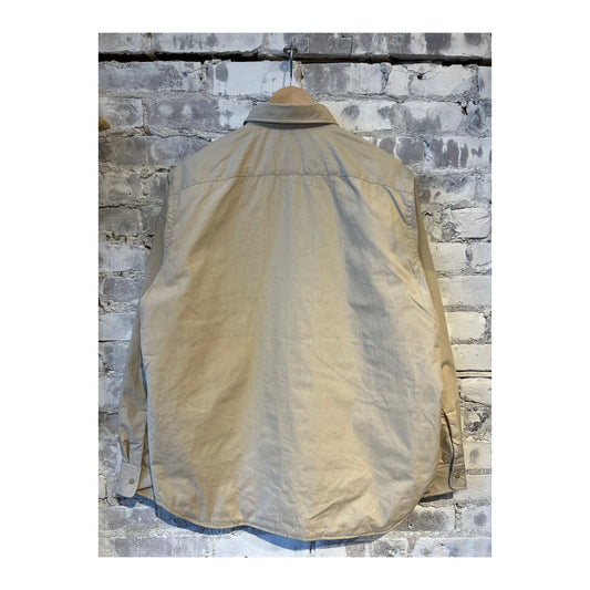 Men's beige nanamica insulation shirt jacket with a stand collar, featuring quilted design and front button closure.