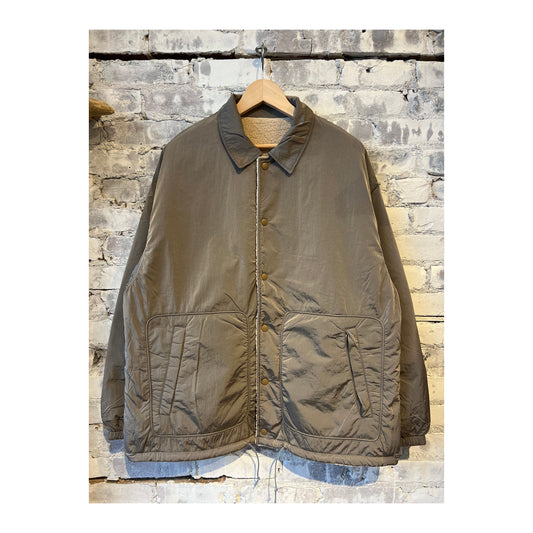Men's beige reversible wind jacket by nanamica, showing both outer and inner sides with lightweight, windproof fabric.