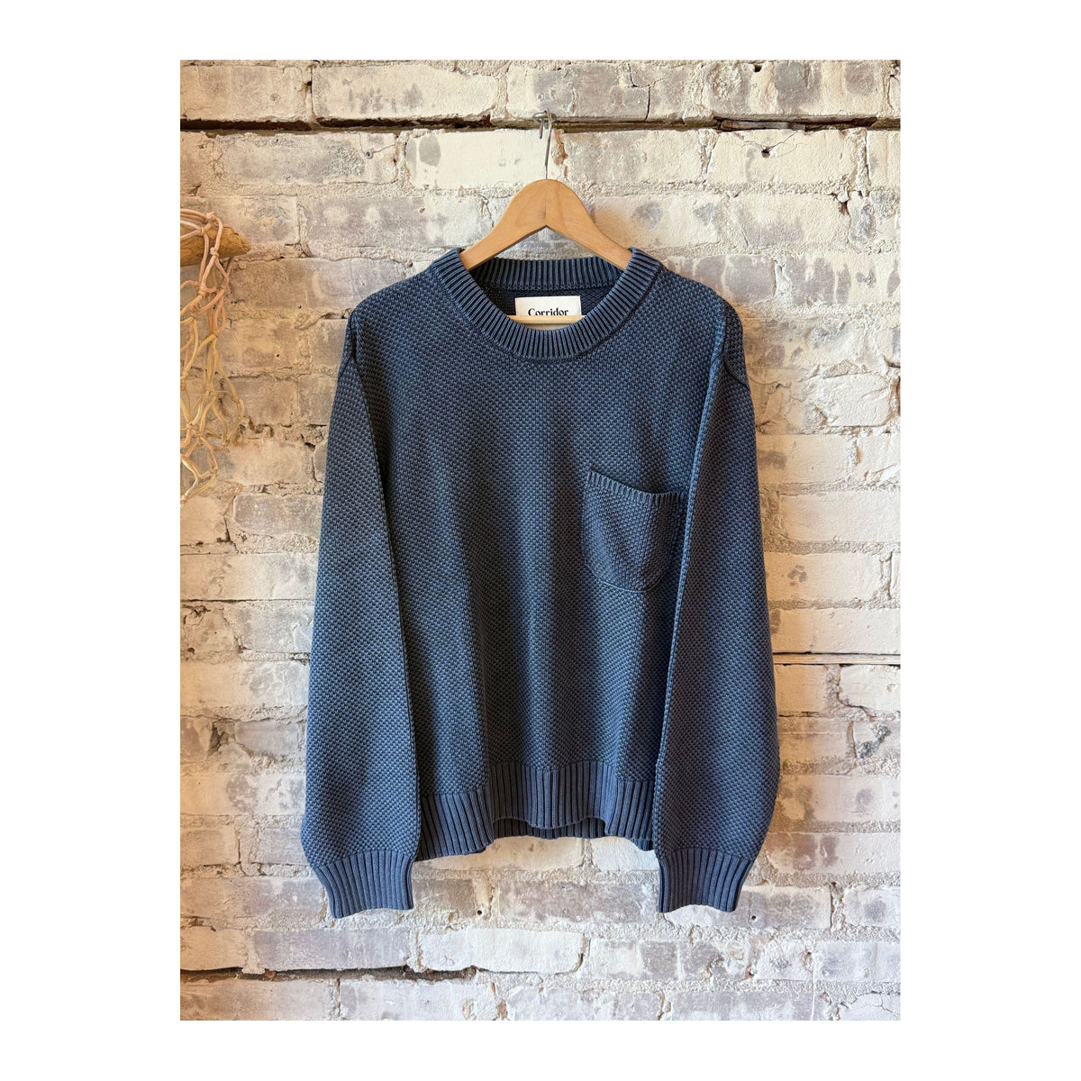 Men's navy pocket crewneck sweatshirt by Corridor, showing the front view with a chest pocket and classic crewneck design.
