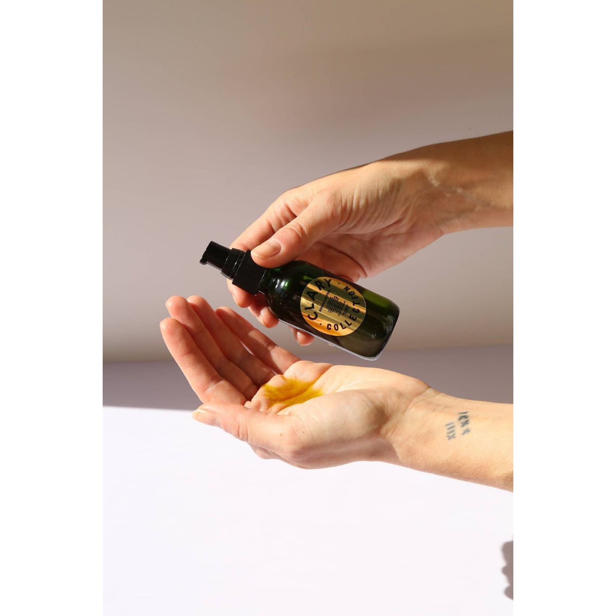 Clary Collection Renew + Repair Oil 2oz bottle, close-up of the natural skincare accessory with dropper cap.