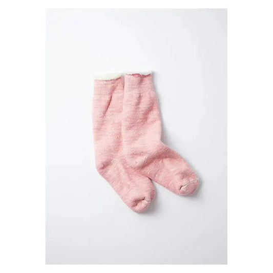 Men's double-face crew socks by Rototo in light pink, showing the soft, knit fabric and stylish two-tone design.