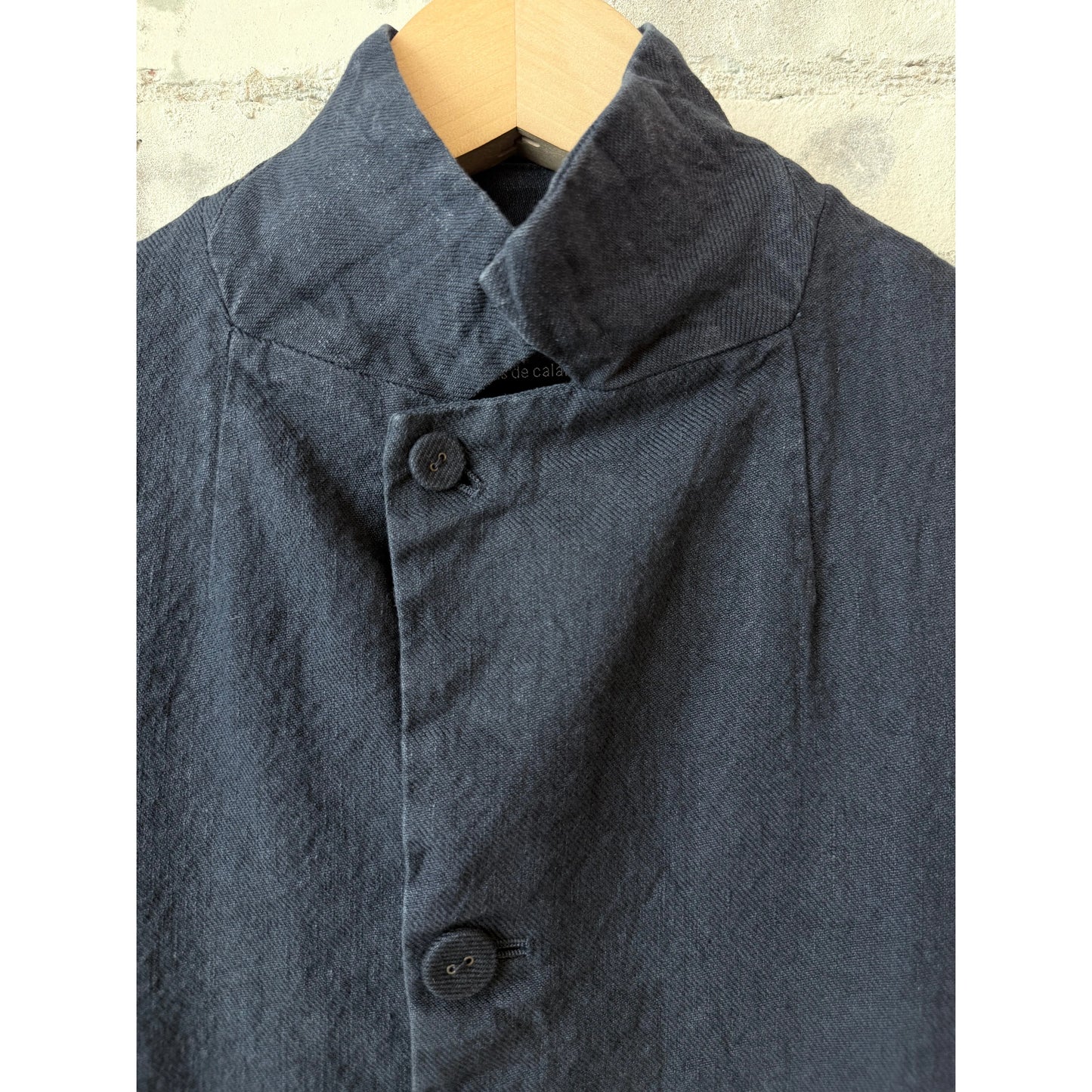 Women's navy cotton-linen jacket by Pas de Calais, soft-washed fabric with relaxed fit and classic collar, displayed on a hanger.