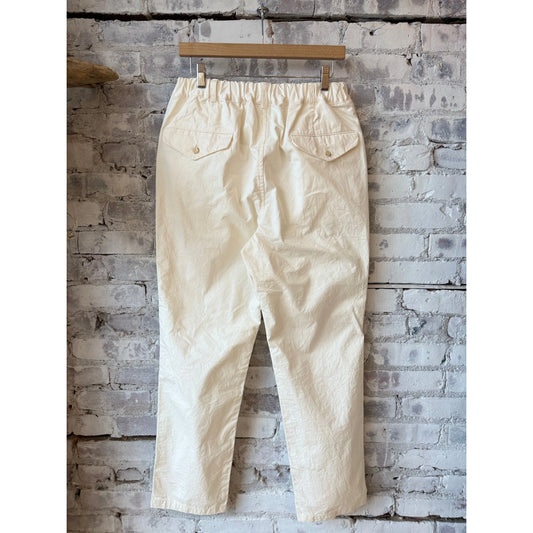 Men's Sage De Cret tapered chino cloth pant in off-white, showcasing the slim fit and casual style with front pockets.