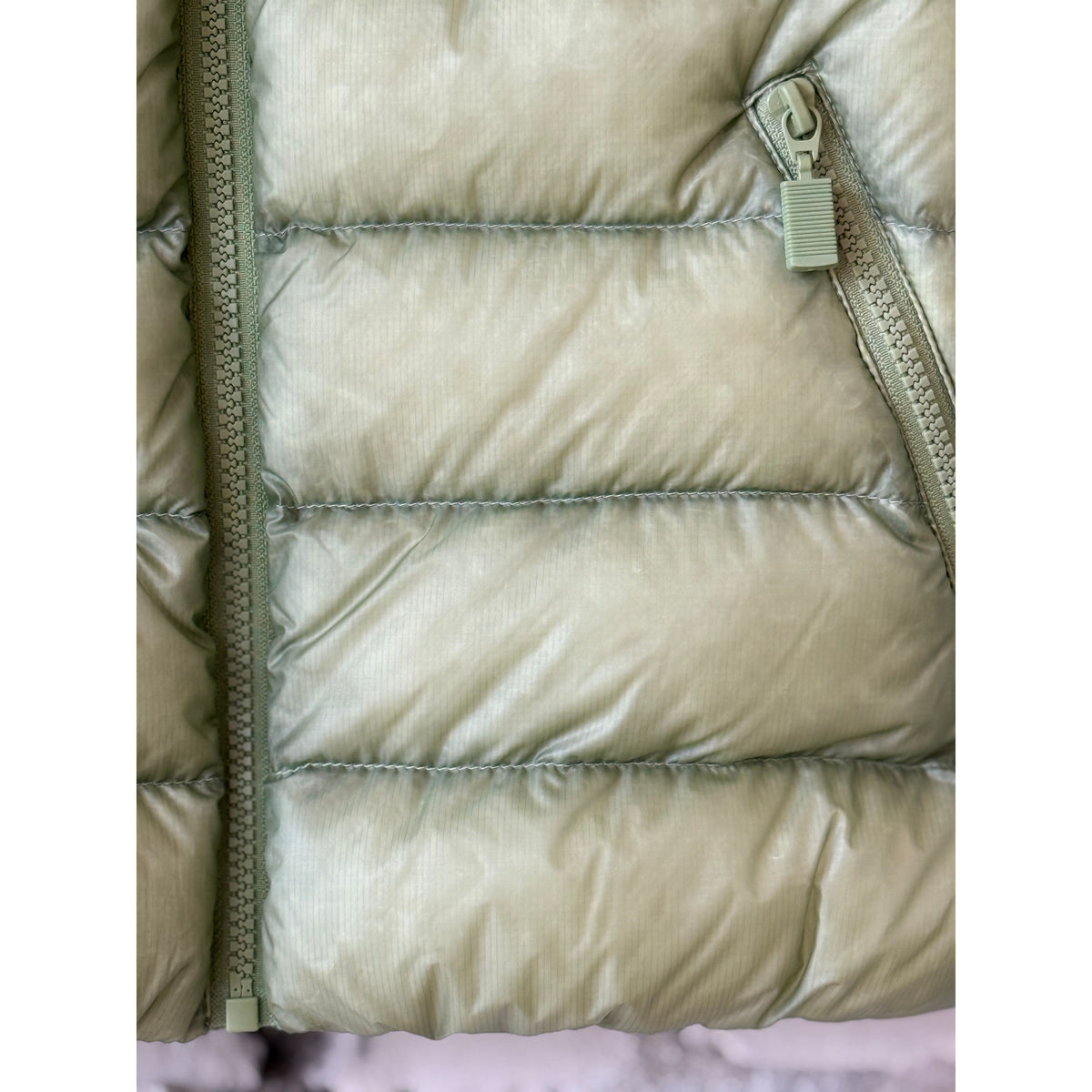 Women's Ultralight Ripstop Nylon Vest in sage green by Aspesi, showing a lightweight, sleeveless vest with a smooth, durable fabric.