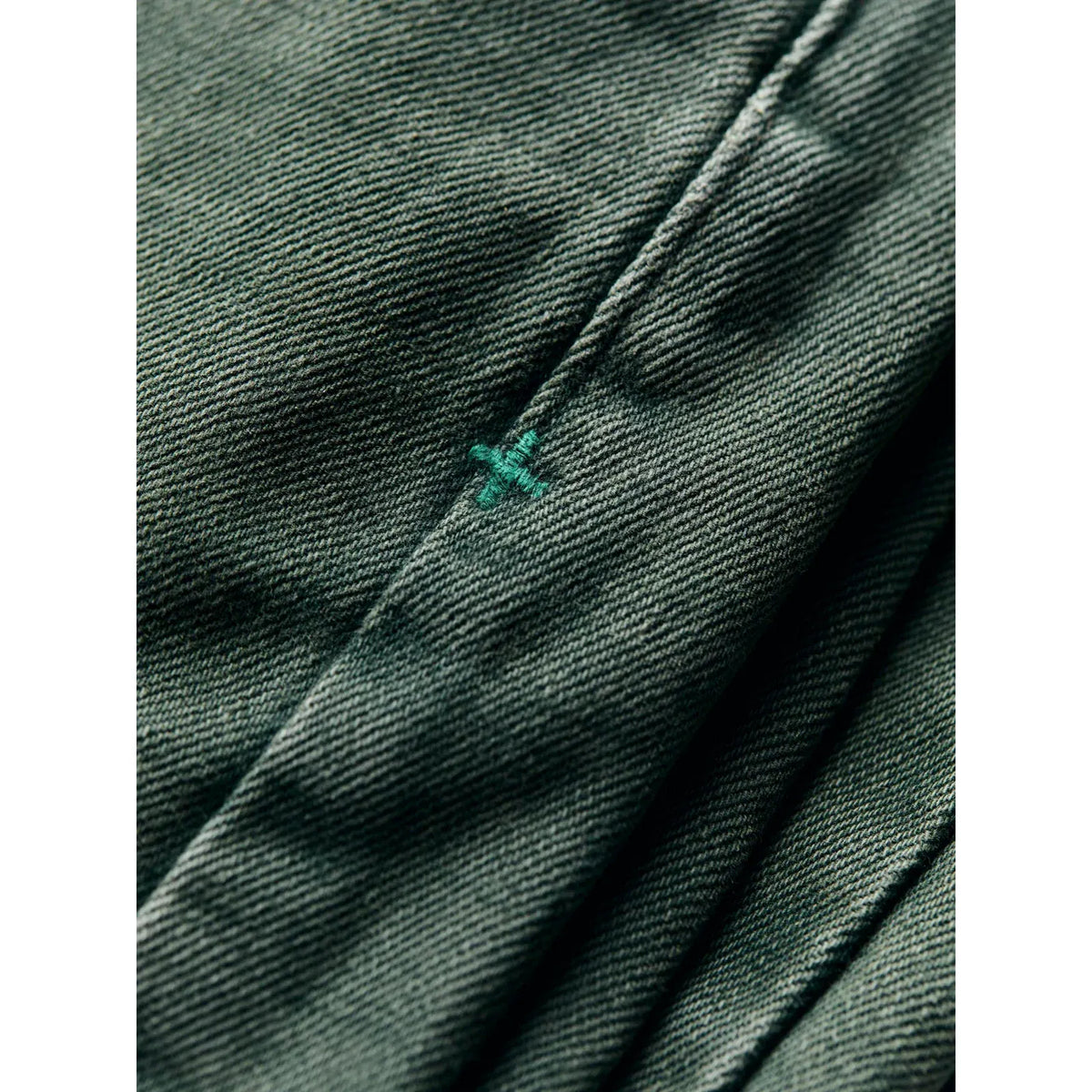 Men's Russell Selvedge Jean in Washed Spruce by imogene + willie, shown in a close-up of the denim fabric and stitching details.