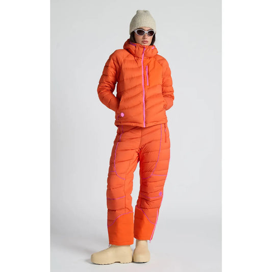 Women's Wildpuff Packable Removable Hood Jacket by Seniq in spicy color, shown with the hood removed and folded for packing.