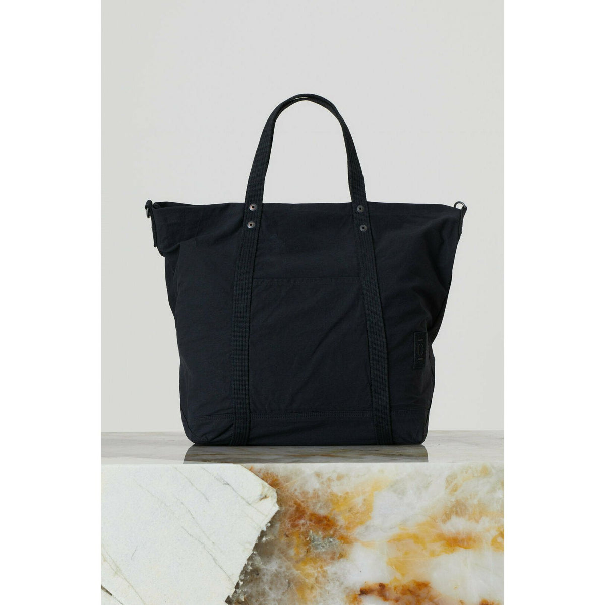Black cotton canvas tote bag by Closed Men's accessories, showcasing a spacious design with sturdy handles.