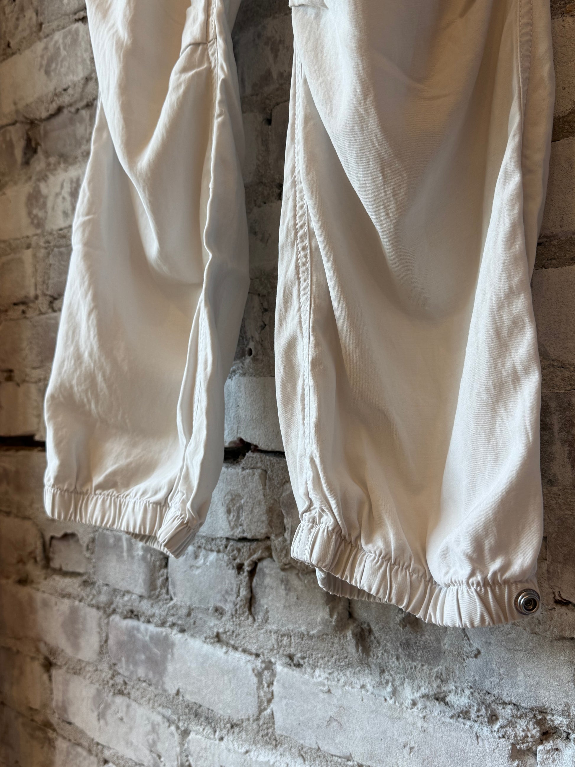 Women's Freecity Airjump Pant in laundry green with matte and satin finish, featuring flap and snap details.