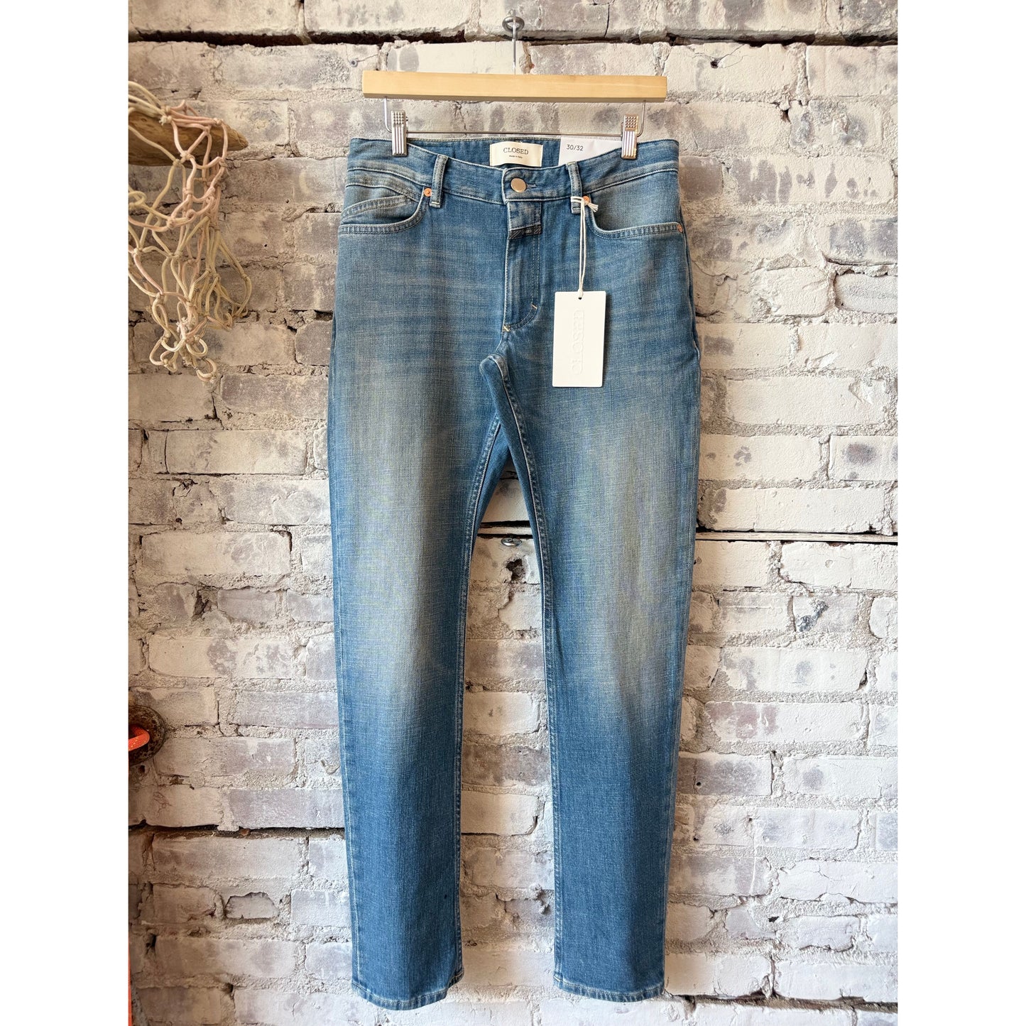 Men's Unity Slim Jean in mid blue by Closed Men's, showing a close-up of the slim fit denim with classic stitching and five-pocket design.