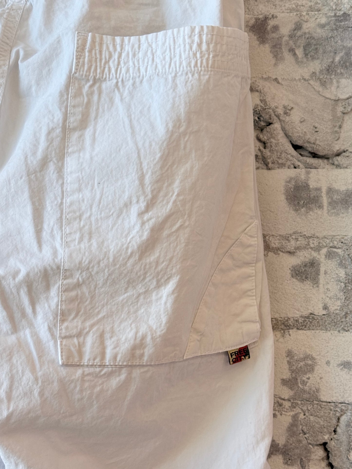 Women's white Homestud Outofsight Poplinair Flapsnap Kite Pants by Freecity, featuring a relaxed fit and stylish design.