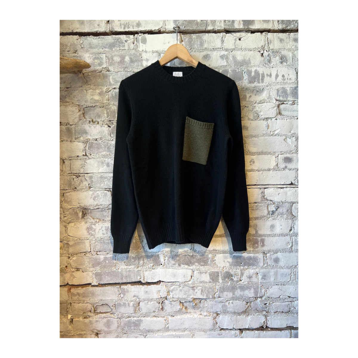 Men's Cashmere Pocket Crew sweater in black and olive, featuring a soft cashmere fabric and front pocket detail.
