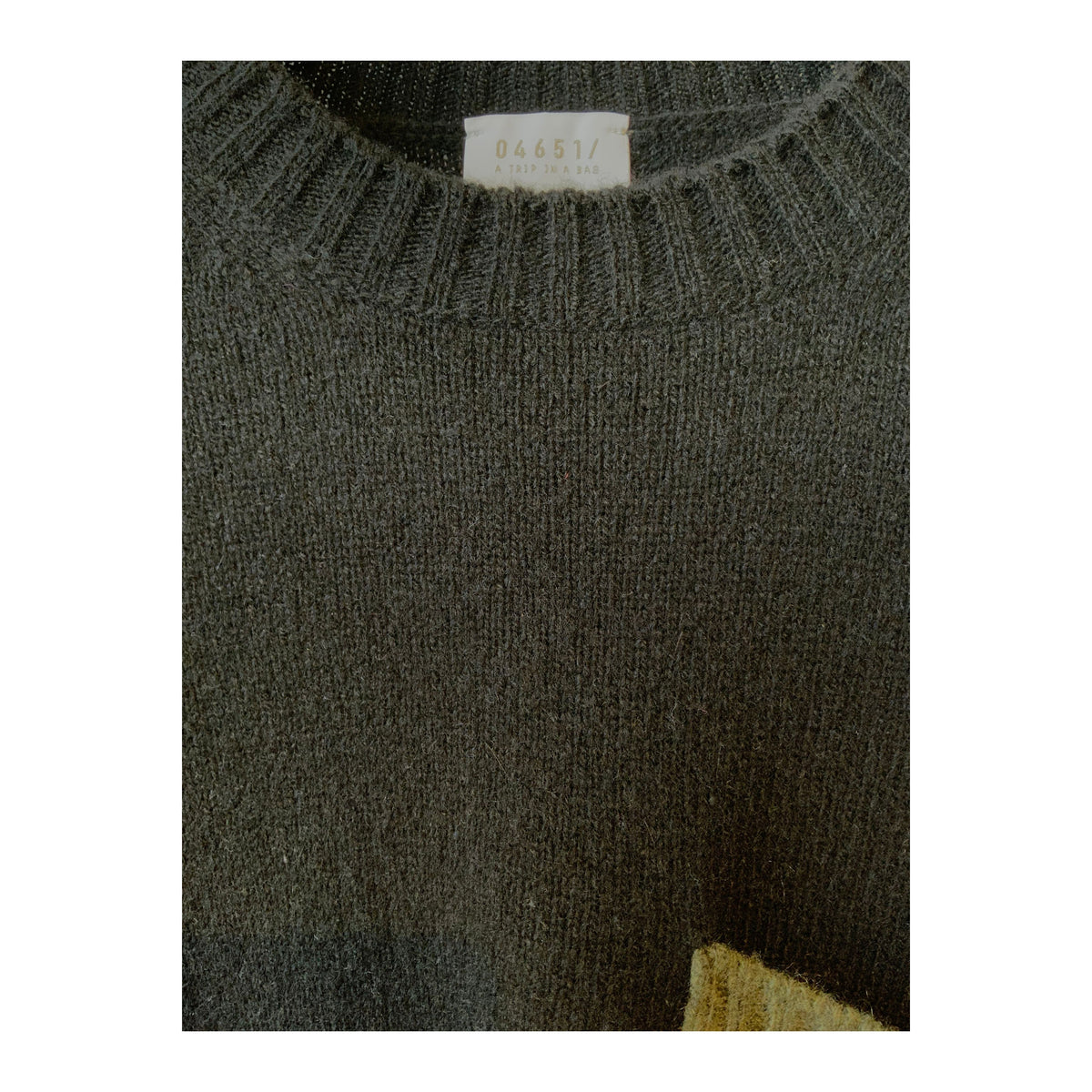Men's black and olive cashmere pocket crew sweater by 04651, featuring a soft, luxurious texture and a stylish pocket detail.
