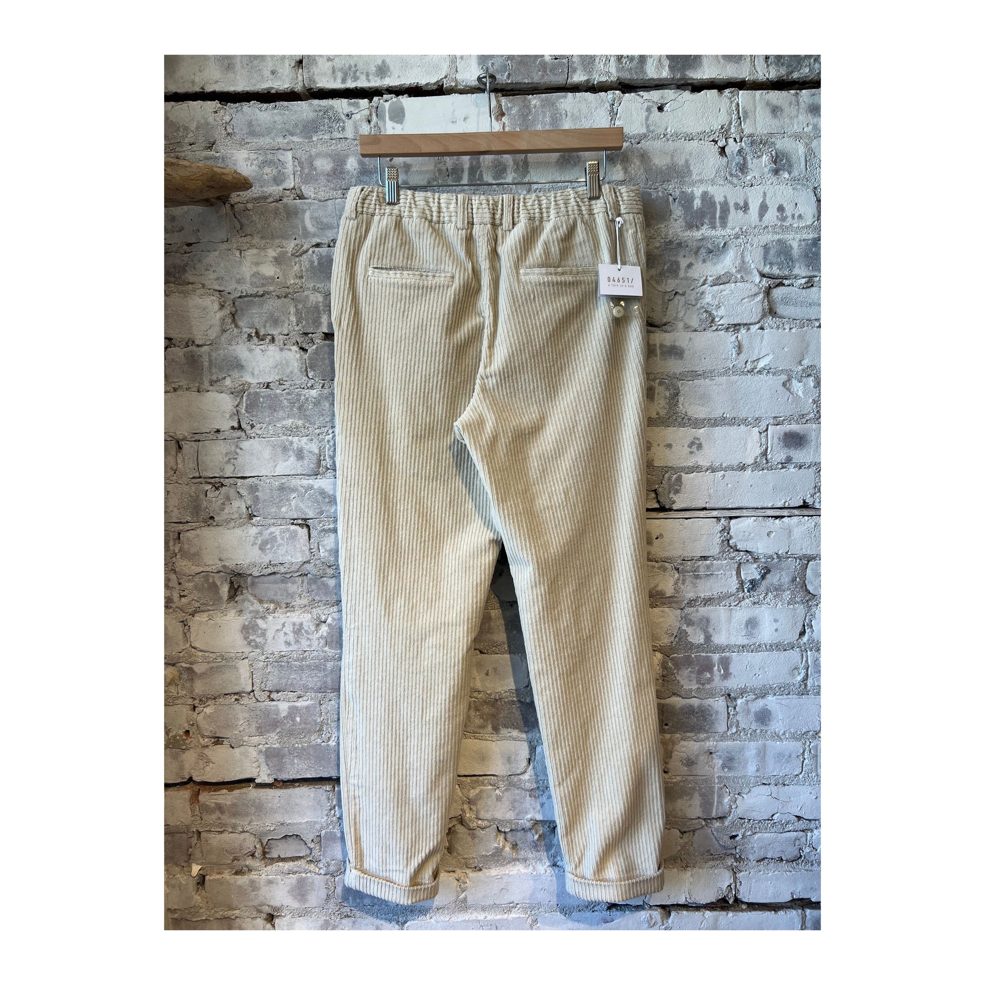 Men's beige corduroy jogger pants with an elastic waistband and relaxed fit, showcasing soft corduroy fabric and stylish casual design.