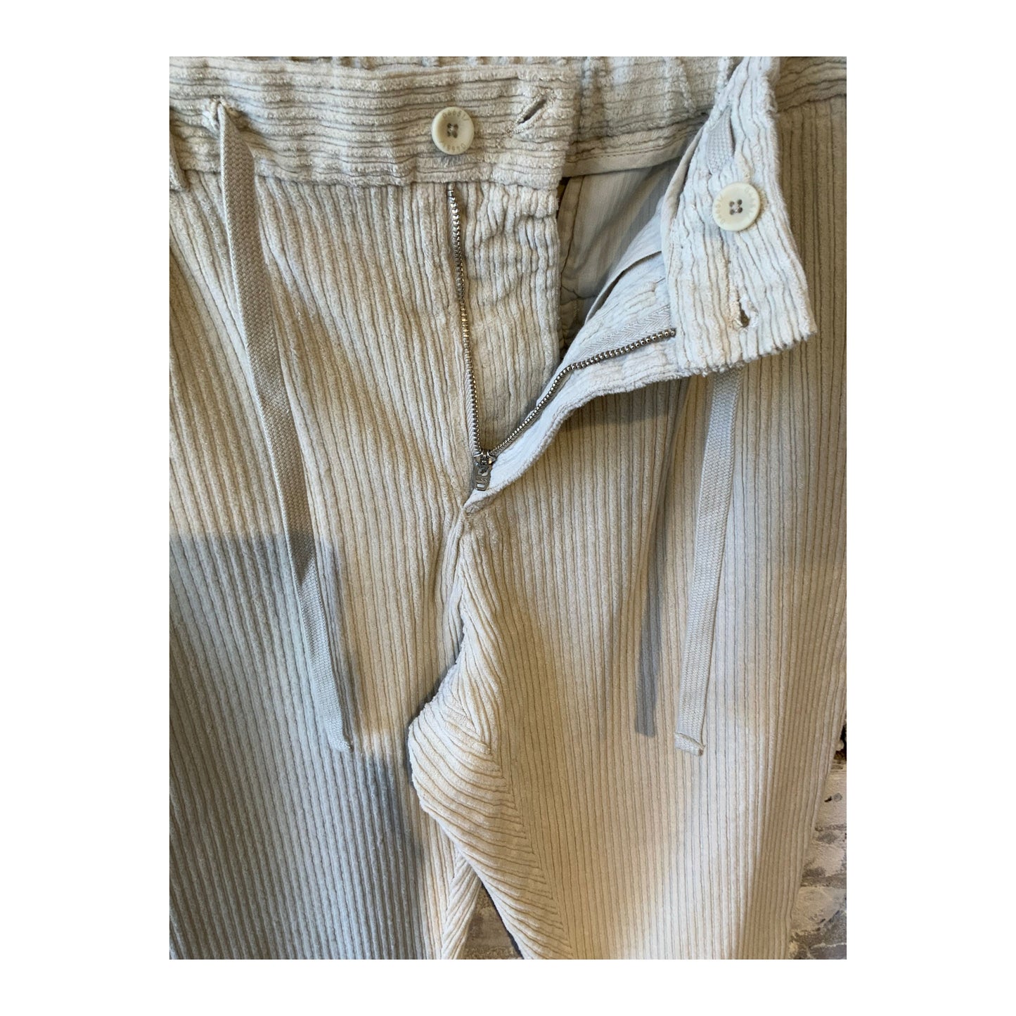 Men's beige corduroy joggers with an elastic waistband and side pockets, casual and comfortable for everyday wear.