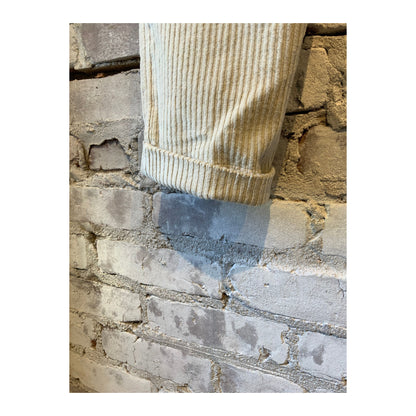 Men's beige corduroy joggers with an elastic waistband and tapered fit, featuring visible corduroy fabric texture.