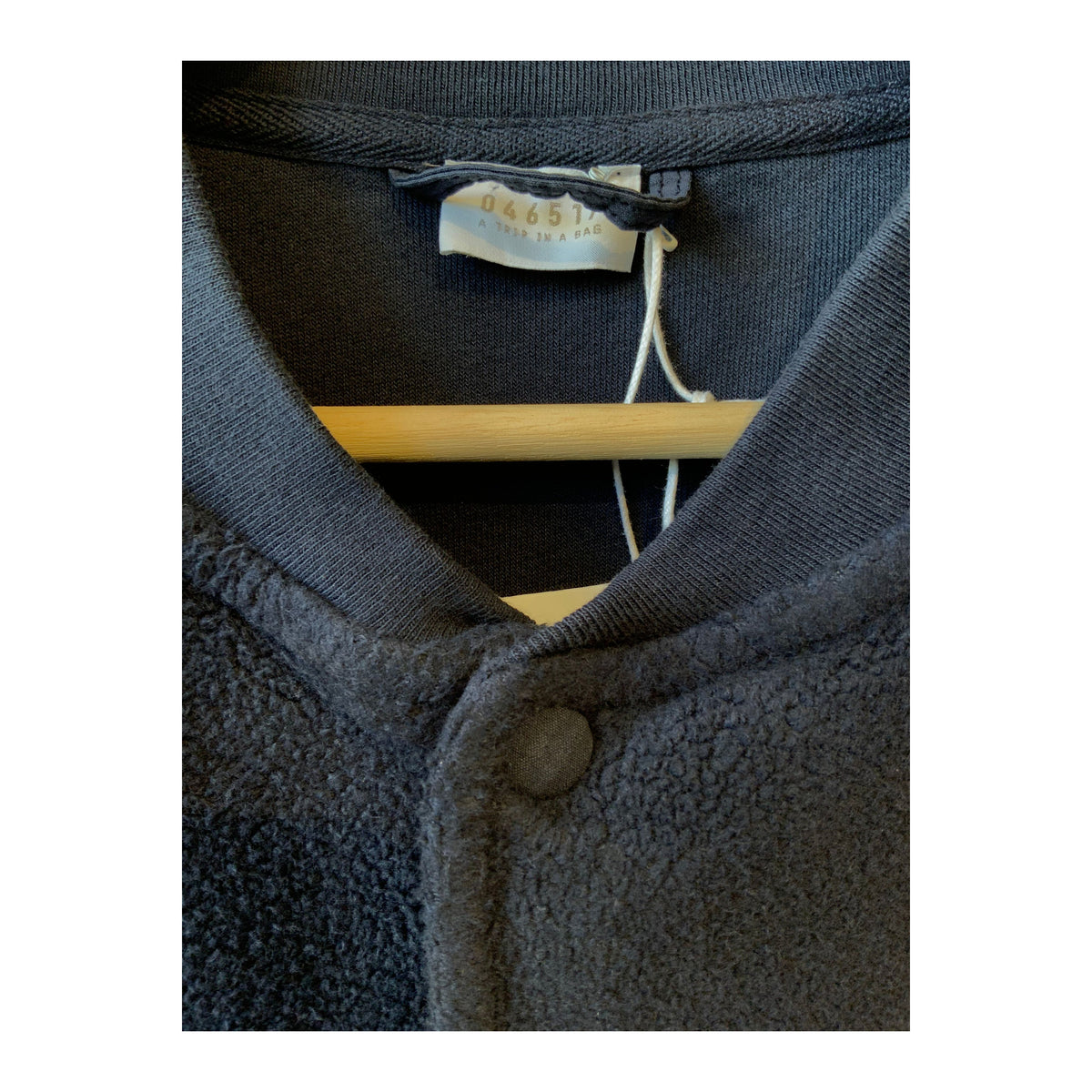 Men's navy PF bomber jacket by 04651, featuring a classic fit with ribbed cuffs and collar, displayed on a hanger.