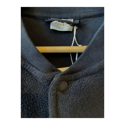 Men's navy PF bomber jacket by 04651, featuring a classic fit with ribbed cuffs and collar, displayed on a hanger.
