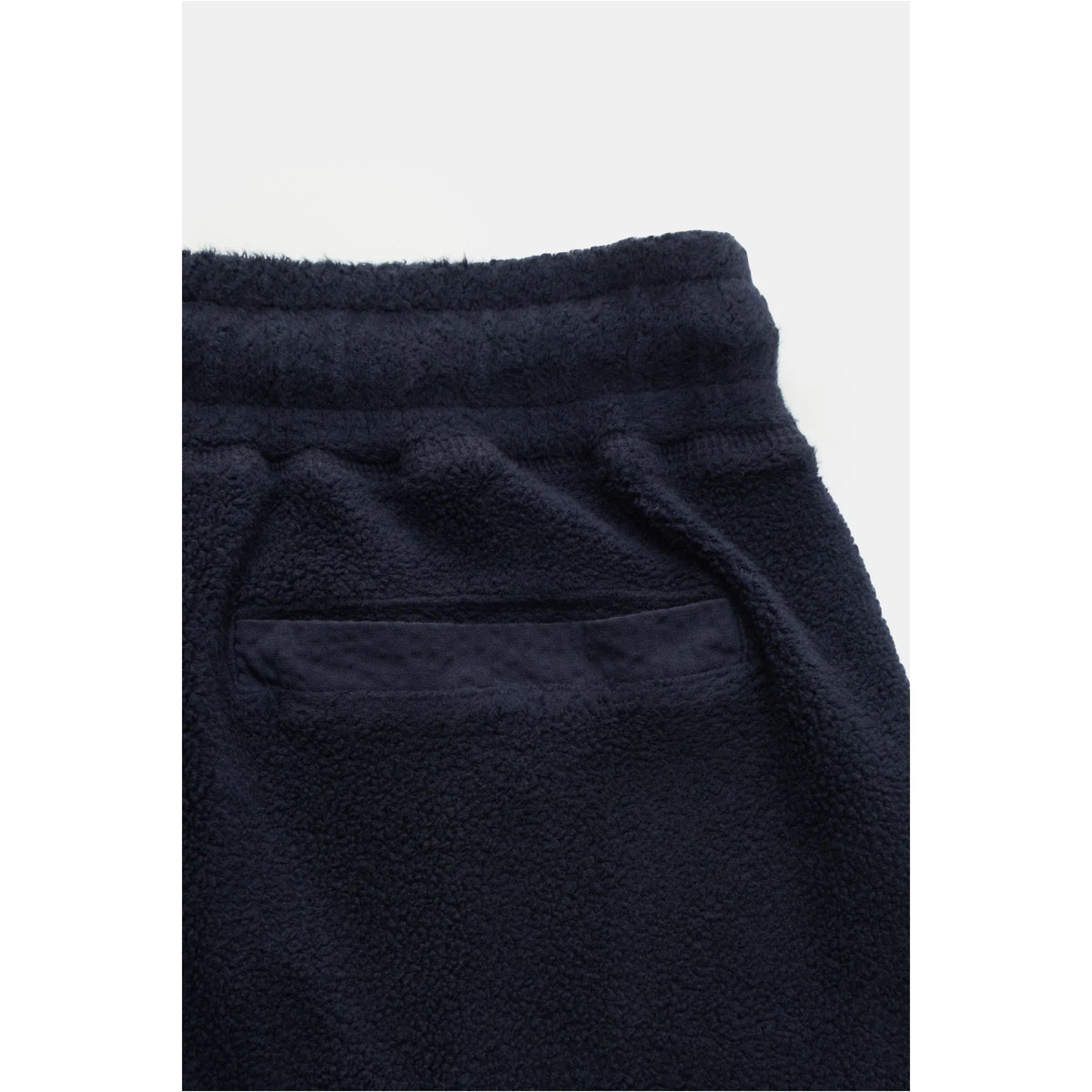 Men's navy PF fleece sweatpants by 04651 with elastic waistband and relaxed fit, shown on a hanger.