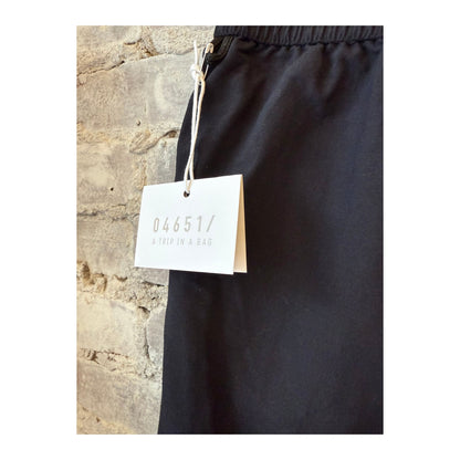 Men's black swim shorts with a relaxed fit and elastic waistband, designed for comfortable beach or poolside wear.