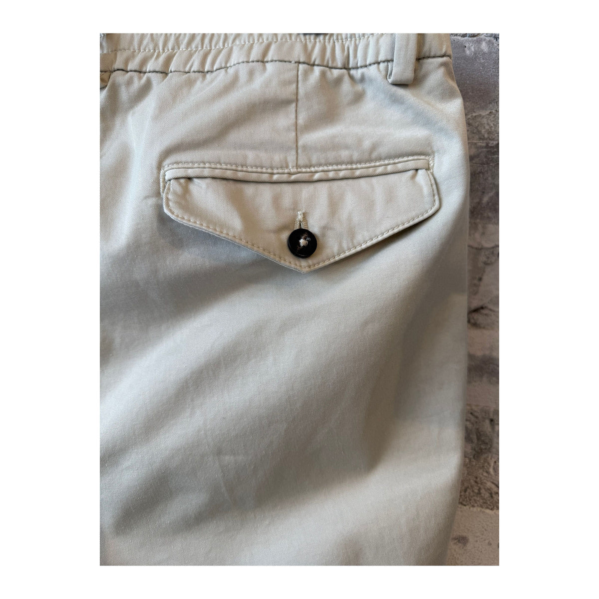 Men's beige twill pants with a relaxed fit, featuring belt loops and side pockets, from the 04651 brand.