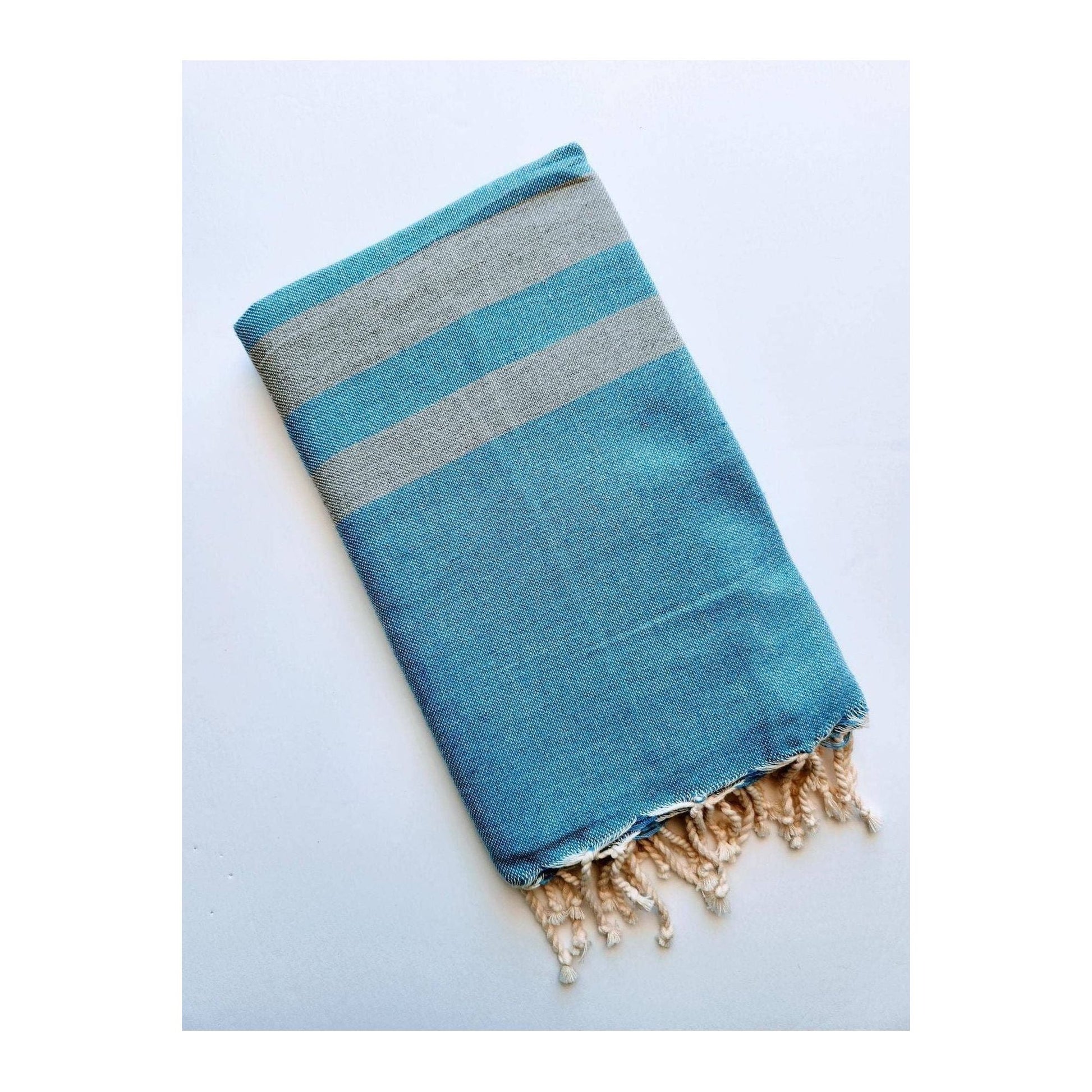 Blue stone Turkish beach towel sarong by wonderfouta, showcasing lightweight fabric and vibrant pattern, ideal as a stylish home accessory.