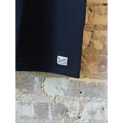 Men's navy Raffy Pique Knit Polo Shirt by Kepani, featuring a classic collar and short sleeves, displayed on a plain background.