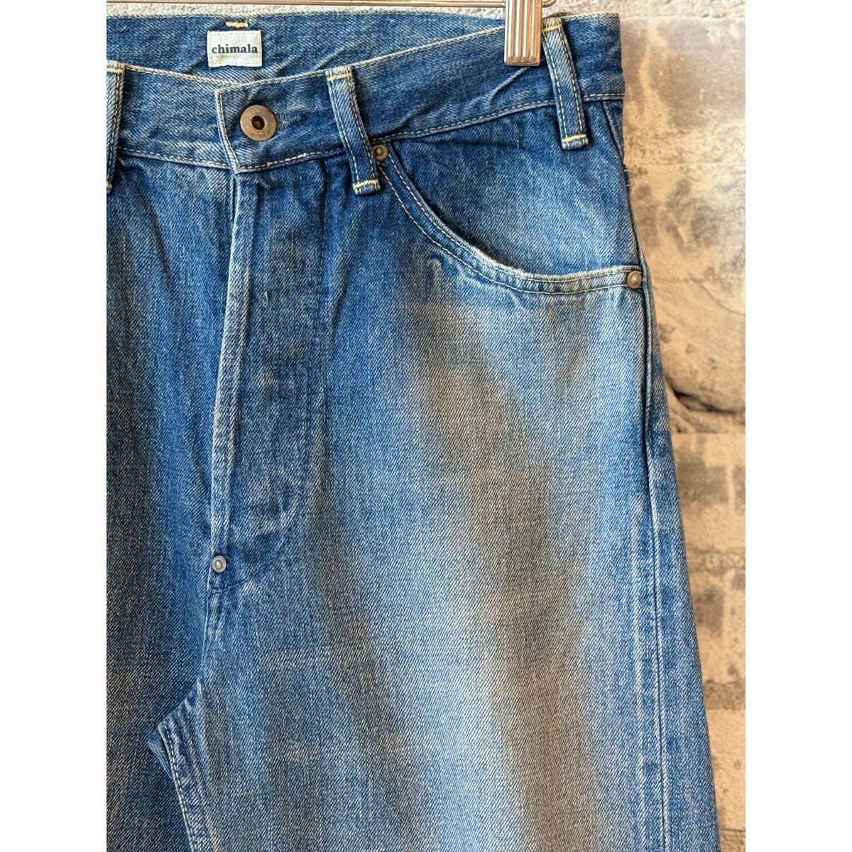Women's 13.5oz dark distress selvedge denim jeans with narrow straight cut by Chimala, featuring a fitted silhouette and distressed details.