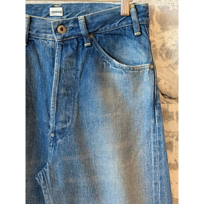 Women's 13.5oz dark distress selvedge denim jeans with narrow straight cut by Chimala, featuring a fitted silhouette and distressed details.