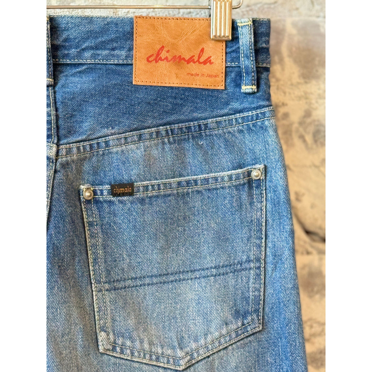 Women's 13.5oz dark distressed selvedge denim narrow straight jeans by Chimala, showcasing a fitted cut with subtle distressing.