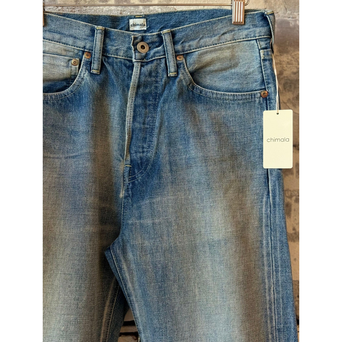 Women's 13.5oz Chimala selvedge denim ankle jeans with medium distress and used wash, showcasing detailed distressed and cuffed hem.