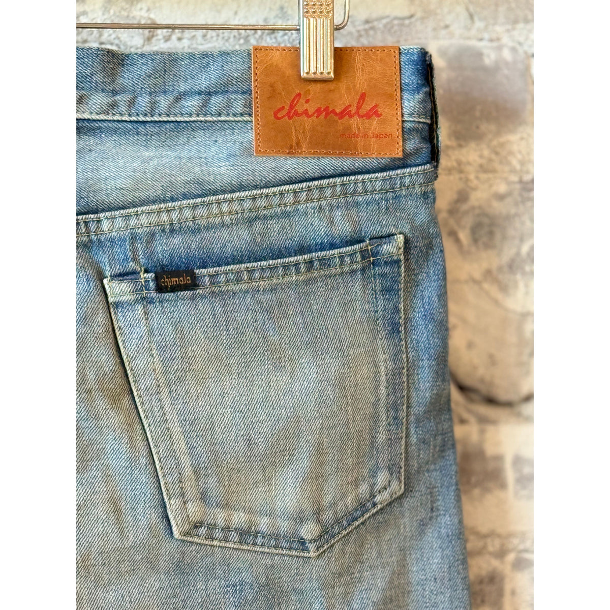 Women's 13.5oz Chimala selvedge denim ankle cut jeans with medium distress and worn-in look, showcasing frayed hems and faded details.
