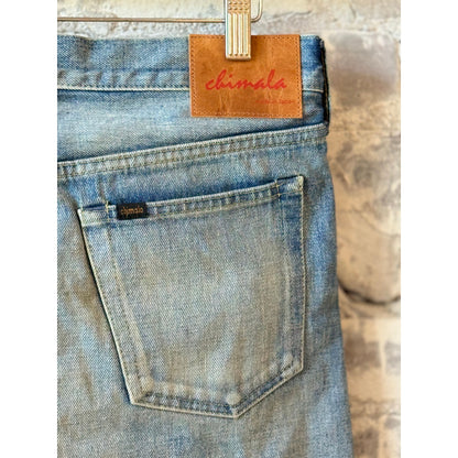 Women's 13.5oz Chimala selvedge denim ankle cut jeans with medium distress and worn-in look, showcasing frayed hems and faded details.