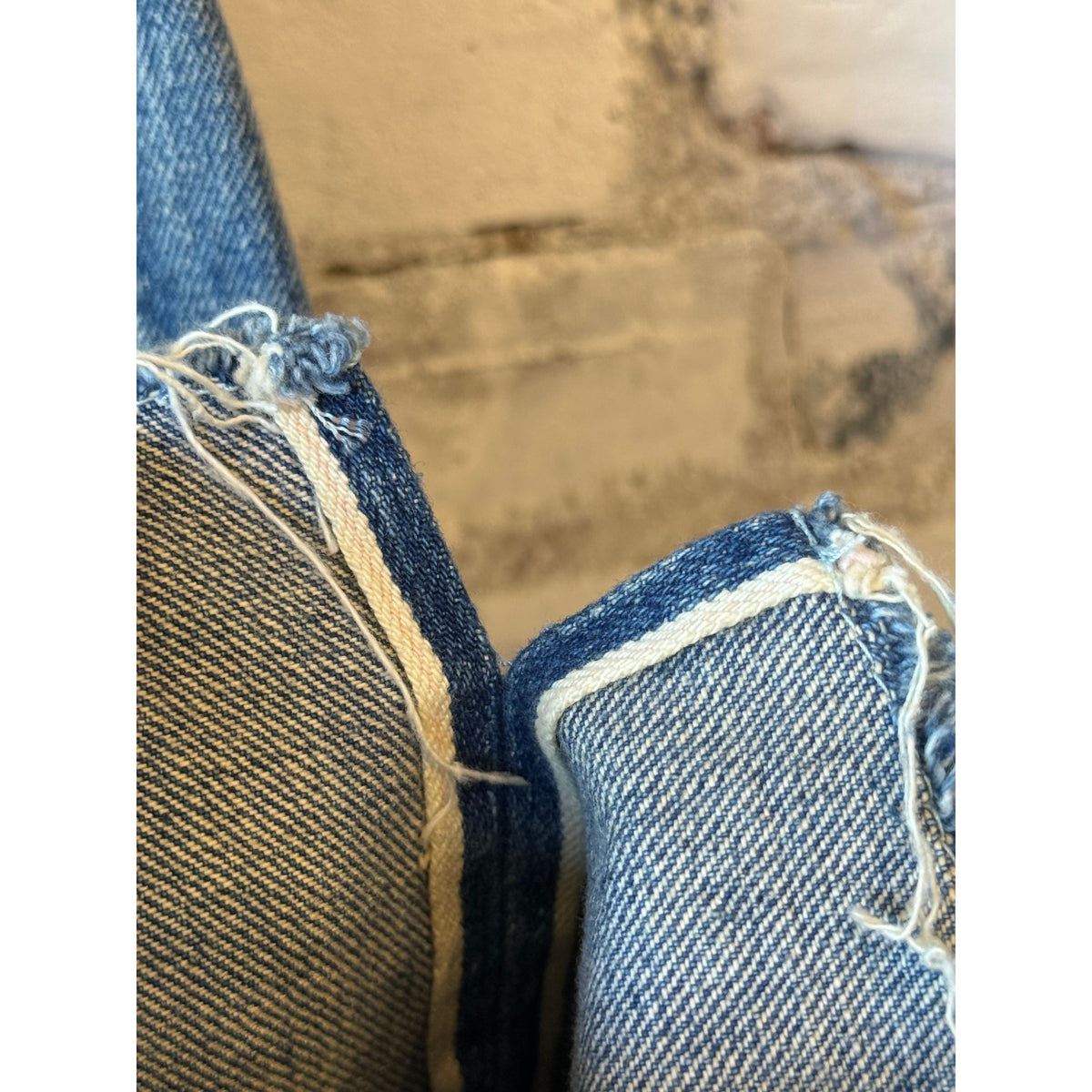 Women's 13.5oz Chimala selvedge denim ankle jeans with medium distress, showcasing a fitted silhouette and distressed hem.