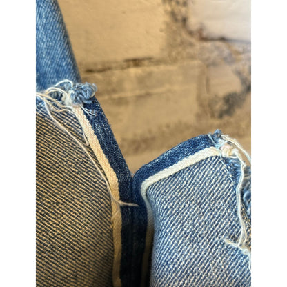 Women's 13.5oz Chimala selvedge denim ankle jeans with medium distress, showcasing a fitted silhouette and distressed hem.