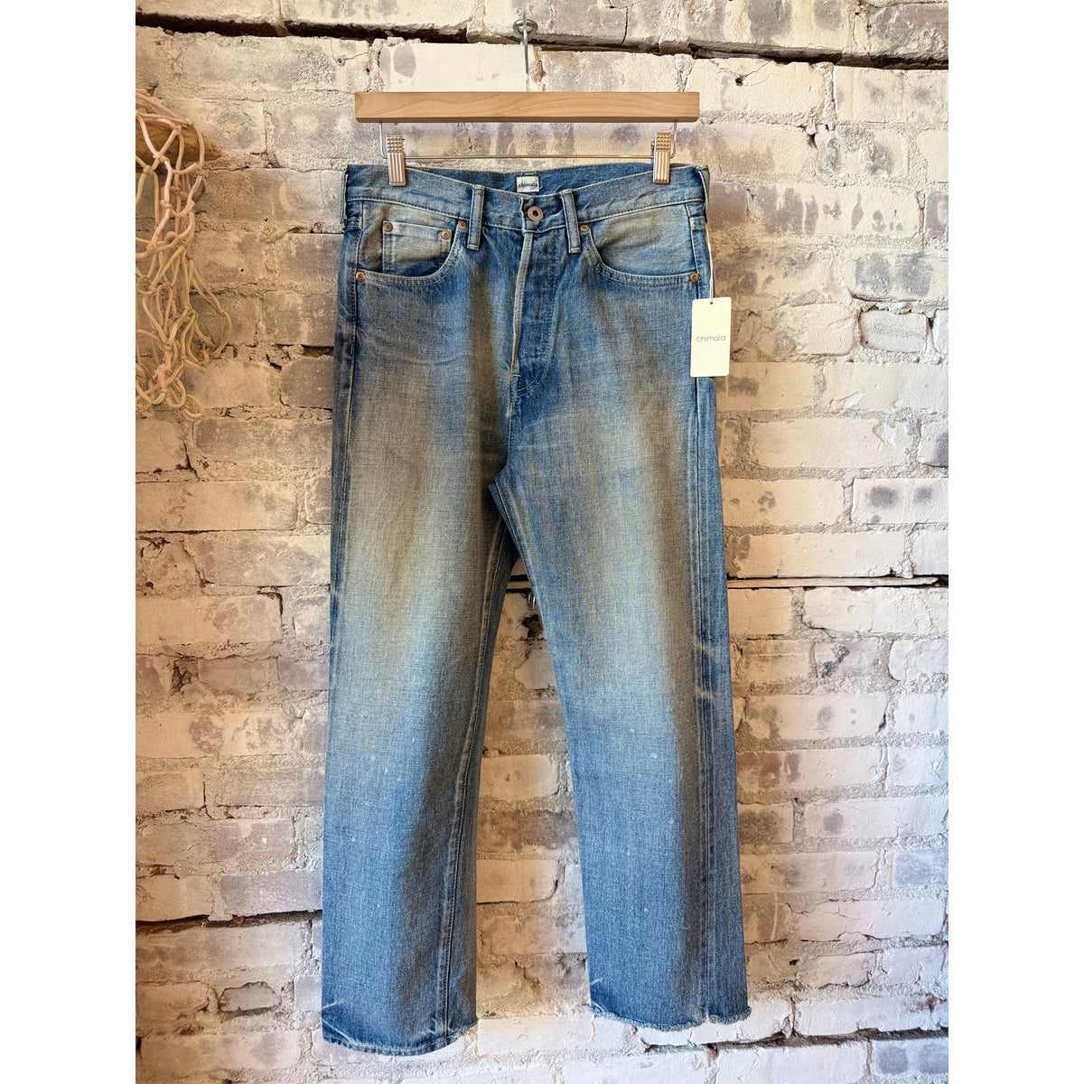 Women's 13.5oz Chimala selvedge denim ankle jeans with medium distress and used wash, showcasing detailed cuff and distressed fabric.