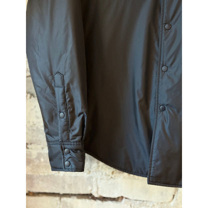 Navy men's 13 Piu shirt by Aspesi displayed on a hanger, showcasing a classic, stylish design in soft fabric.