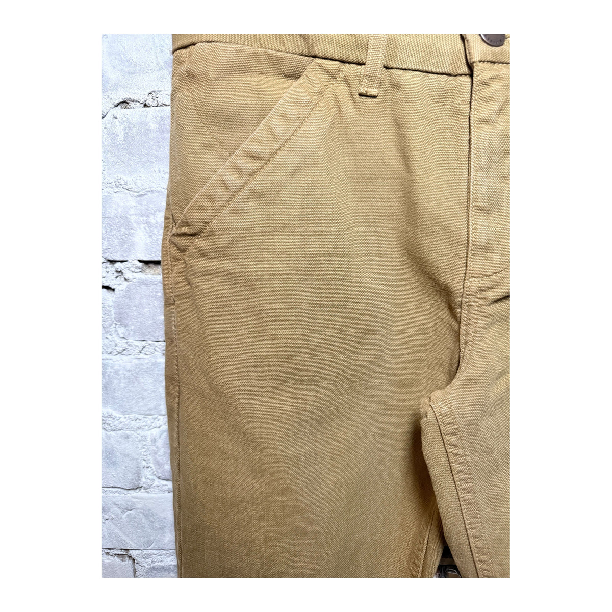 Men's 14-ounce tan slub workman's chino pants by Freenote Cloth, showing the textured fabric and relaxed fit.