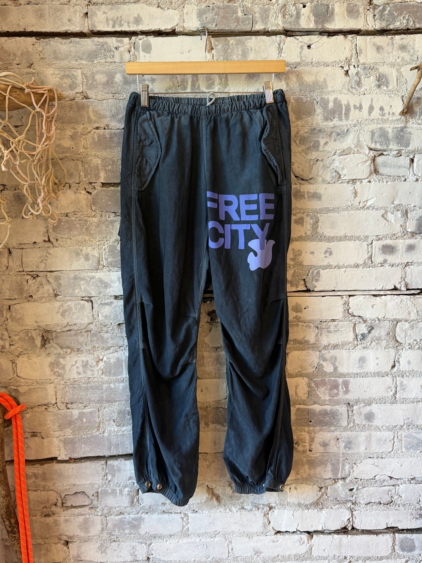 Women's Freecity Airjump Pant in large matte satin fabric featuring flap and snap details, moonshrooms pattern on the fabric.