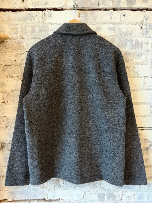 Hartford Men's charcoal knitted jacket, stylish and cozy, shown on a hanger with detailed knit texture.