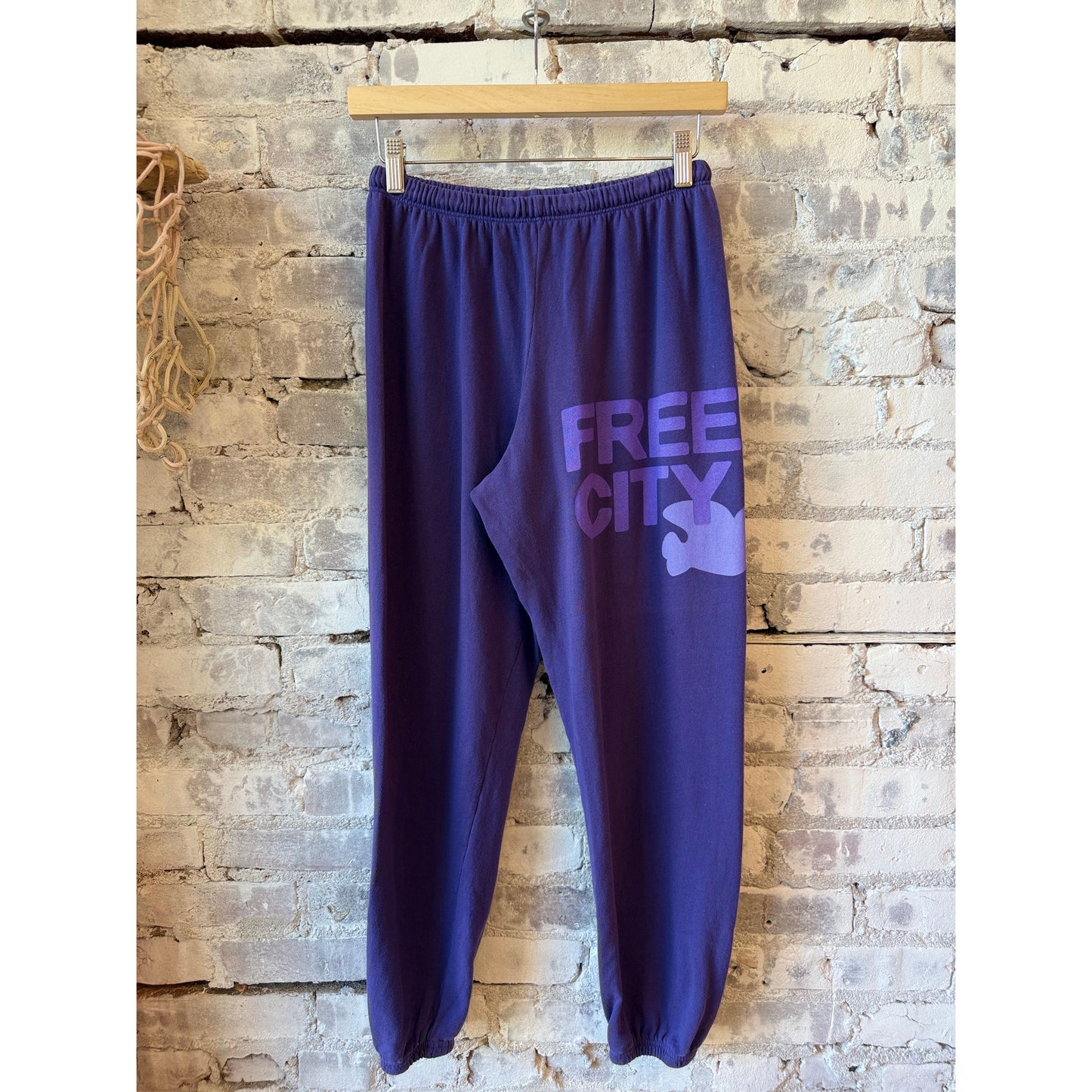 Women's Freecity large purple sweatpants with a floral bush print, casual fit, and comfortable waistband.