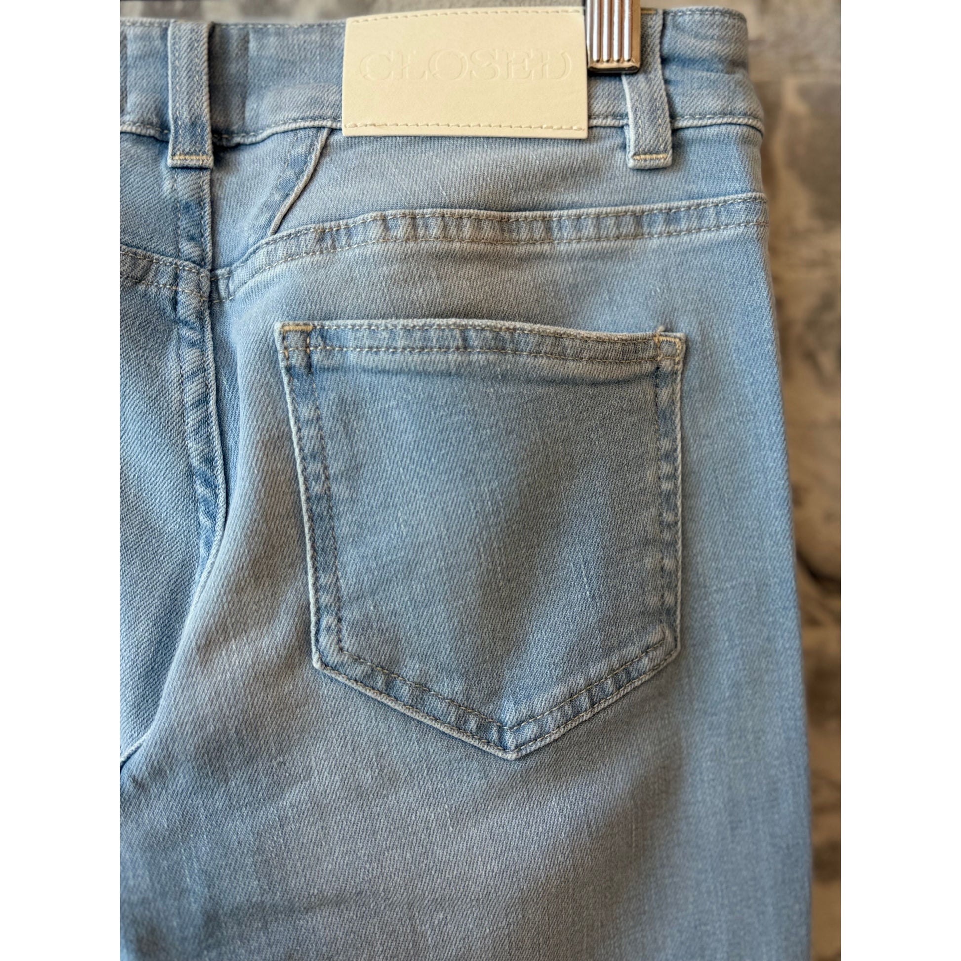 Women's Baker Slim Jean by Closed in light blue denim, showcasing a fitted silhouette and classic five-pocket design.