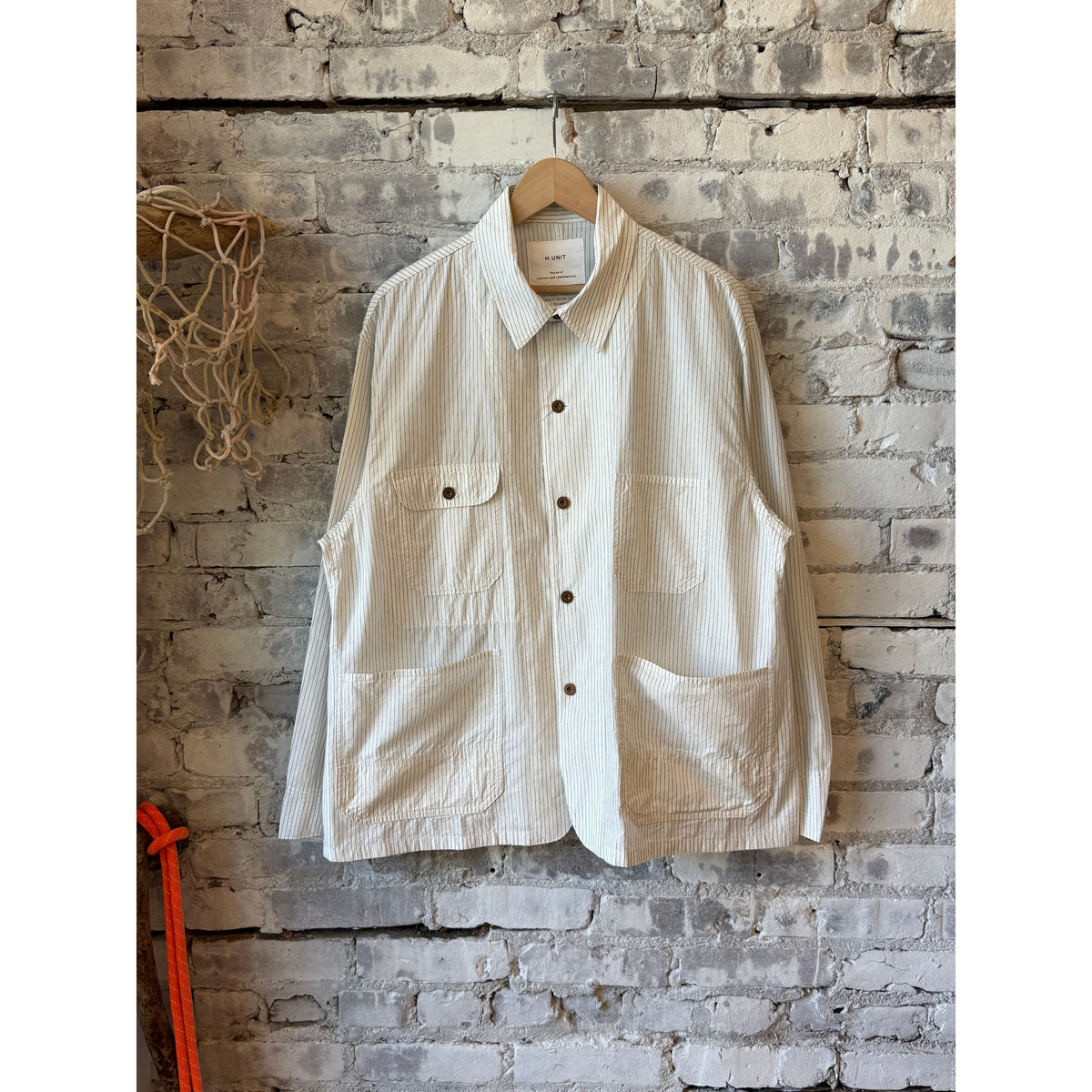 Men's white stripe shirtalls by H-Unit, durable denim overalls with adjustable straps and front pockets, casual workwear style.