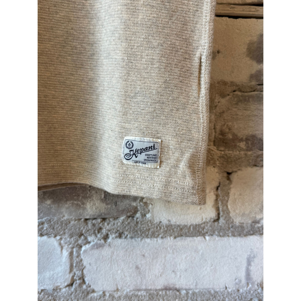 Men's Kepani Raffy crew neck sweatshirt in oatmeal, soft cotton fabric, shown on a hanger with a casual fit