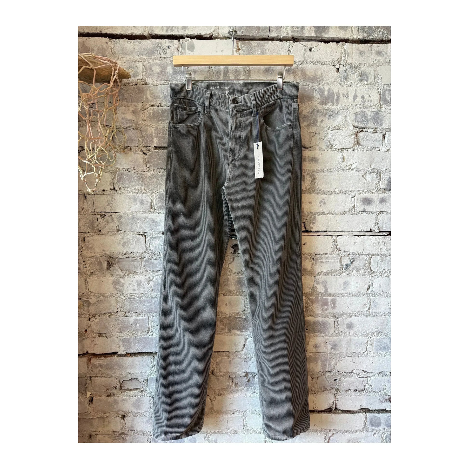 Men's black 5-pocket cord jean by Save Khaki United, showcasing classic denim style and durable fabric.