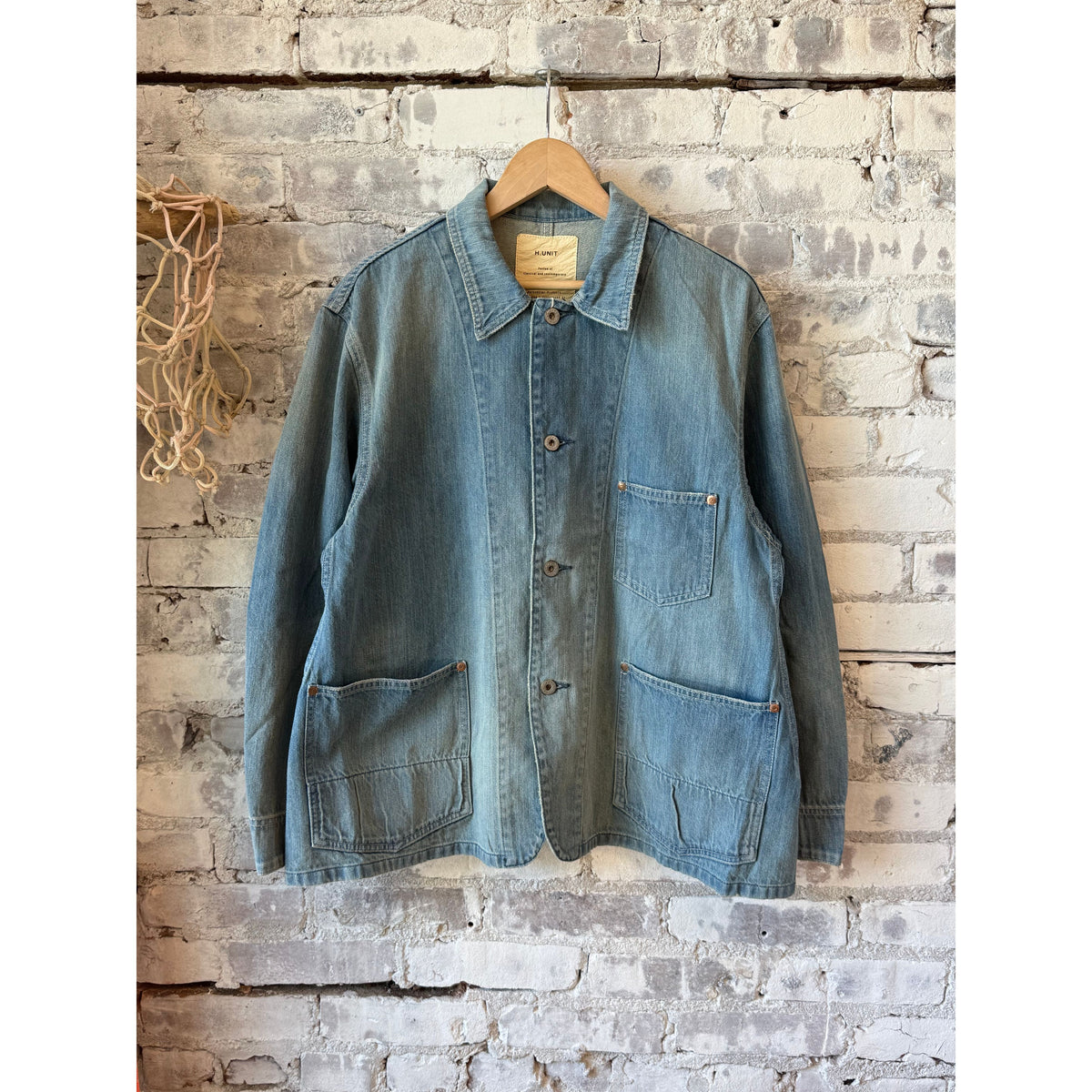 Men's 9oz denim coveralls by H-Unit in light indigo, used wash, with front pockets and adjustable straps.