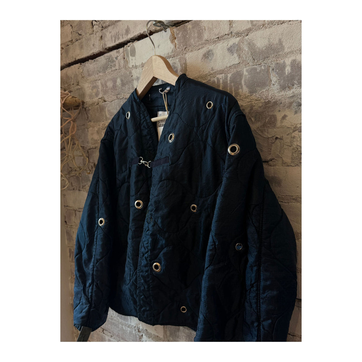 Women's navy military liner grommets by Sloppy Seconds, featuring durable metal eyelets on a navy fabric liner.
