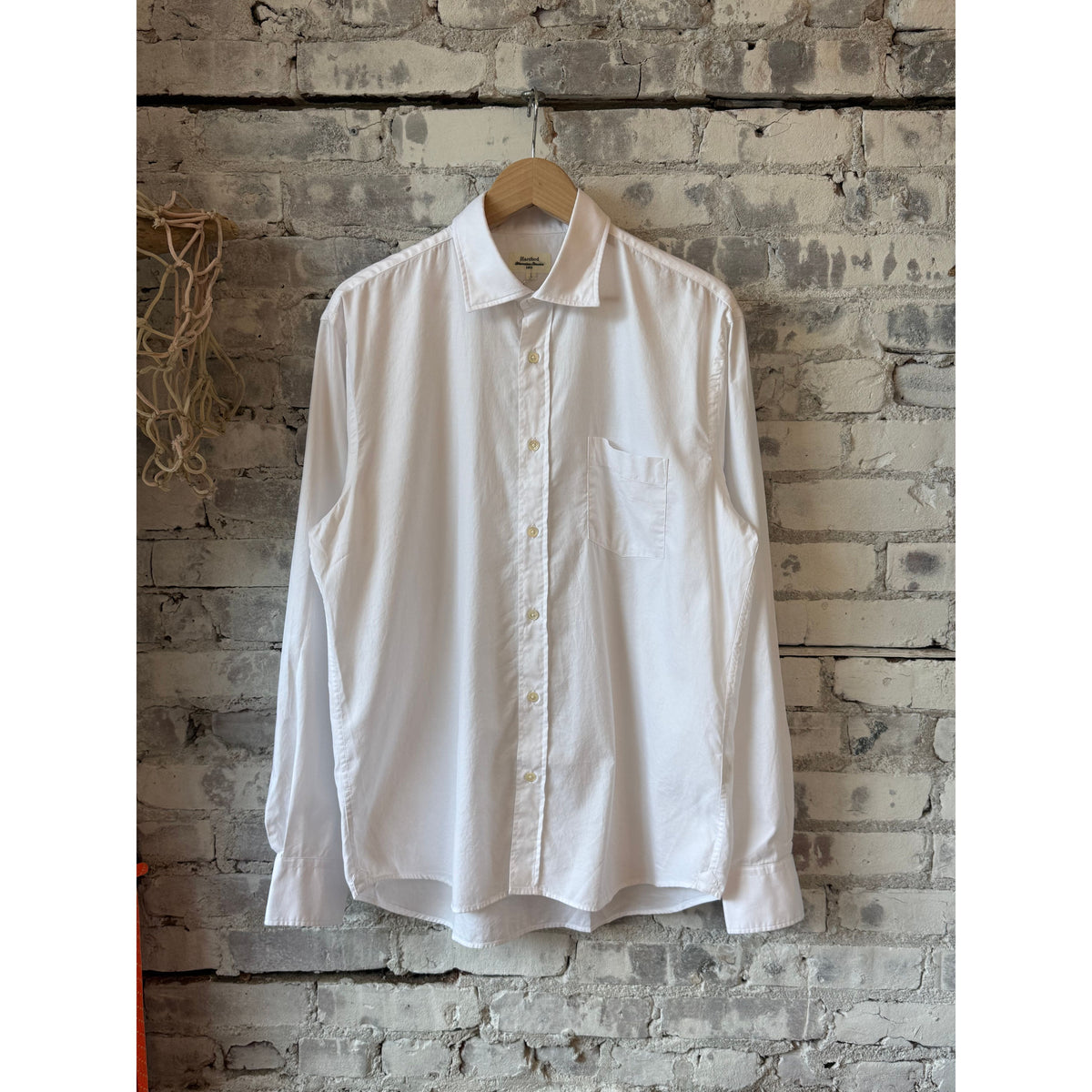 White Paul woven men's shirt by Hartford Men's, shown with a close-up of its textured fabric and classic collar.