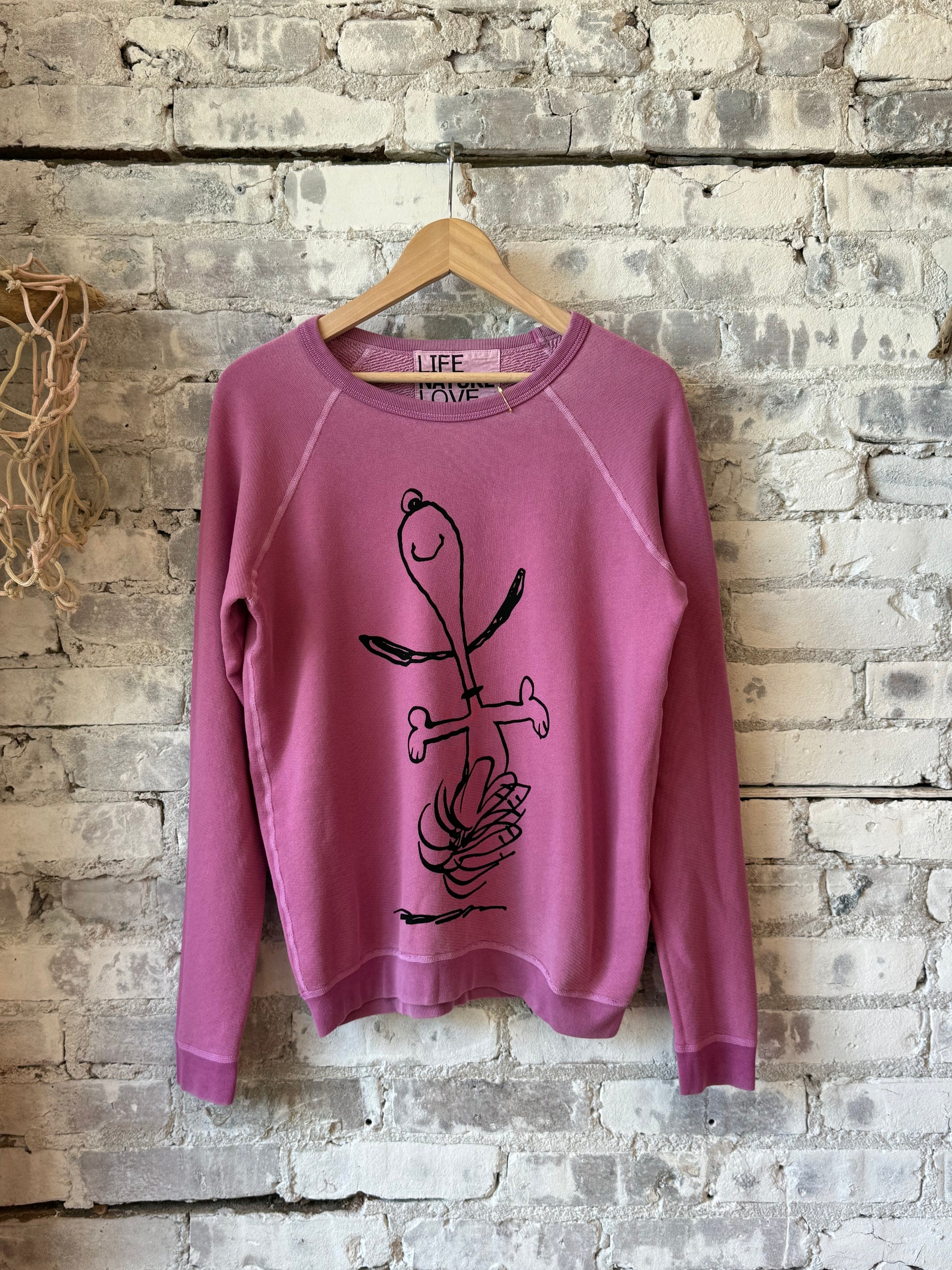 Women’s pink Snoopy Yumm Raglan shirt by Freecity, featuring a vintage Schulz Super design with a relaxed fit and soft fabric.