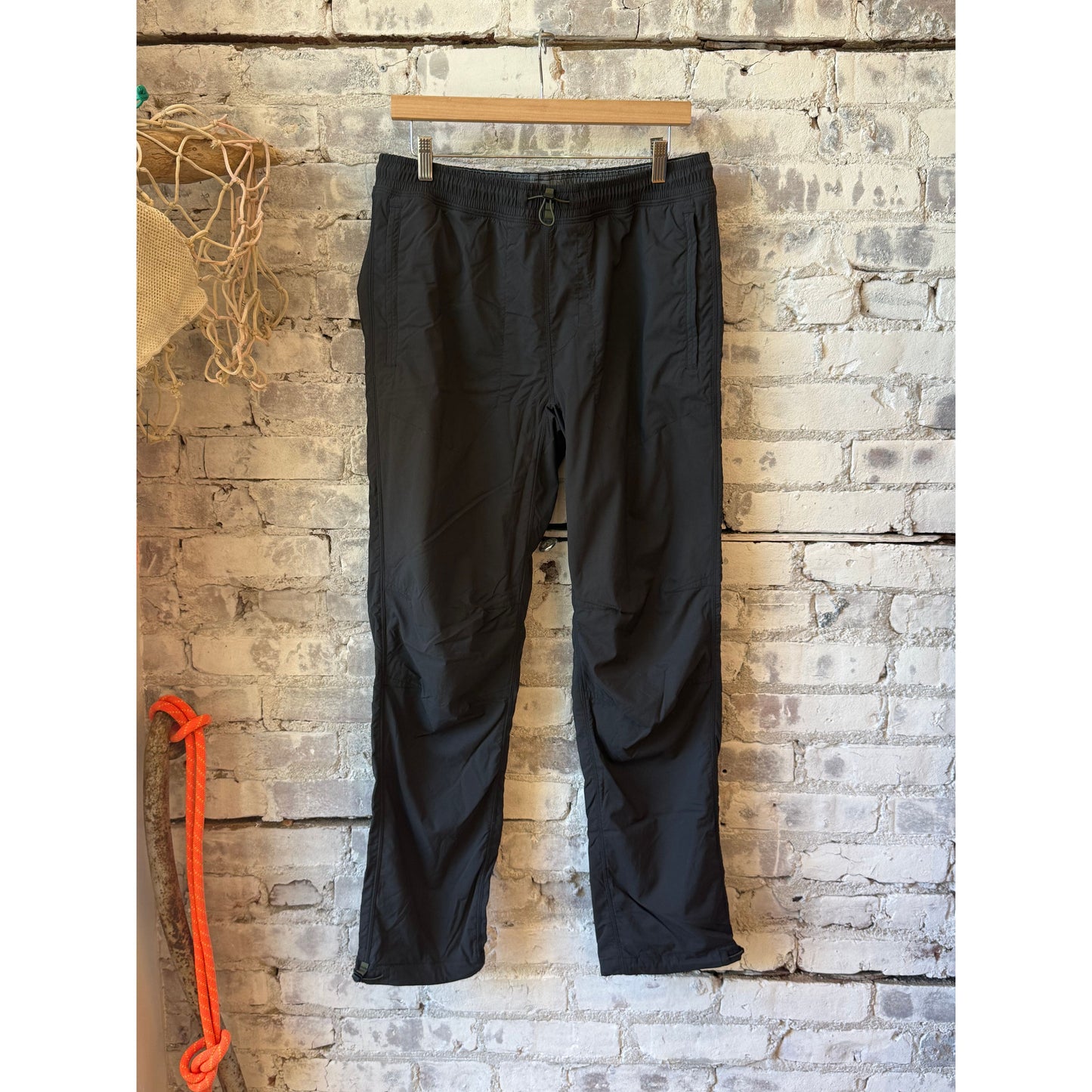 Men's black fade off-trail windpant by Relwen, showing the lightweight fabric and relaxed fit suitable for outdoor activities.